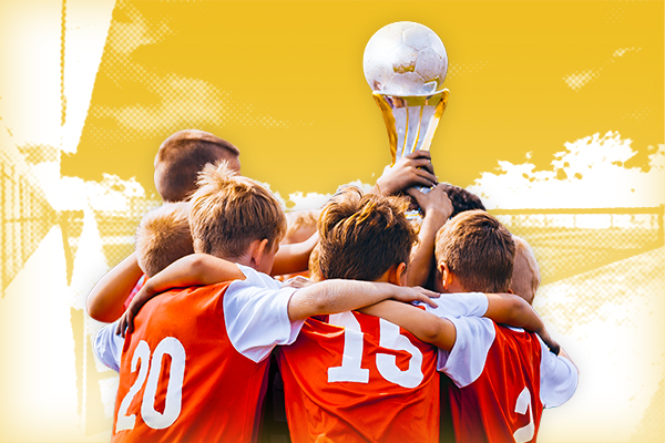 Soccer players holding a trophy